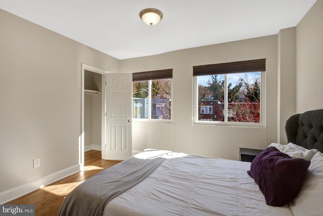 bedroom featuring wood finished floors and baseboards