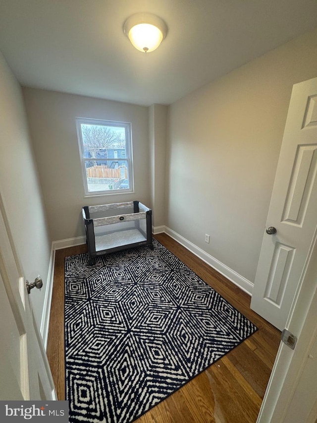 interior space with dark wood-style floors and baseboards