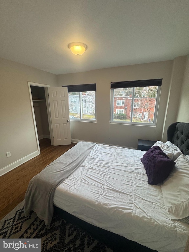 bedroom with wood finished floors and baseboards