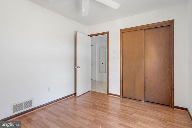 unfurnished bedroom featuring a closet, ceiling fan, and light wood-type flooring