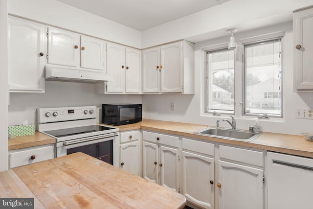 kitchen featuring white appliances, sink, and white cabinets