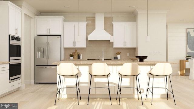 kitchen with white cabinetry, stainless steel appliances, custom range hood, and a center island with sink