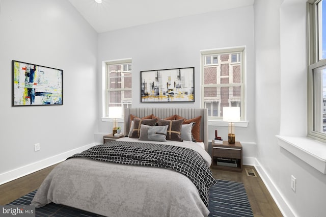 bedroom featuring baseboards, visible vents, and dark wood-style floors