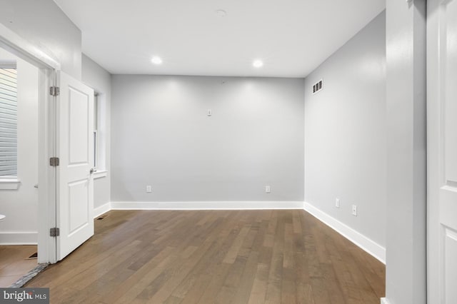 interior space with visible vents, baseboards, recessed lighting, and dark wood-type flooring