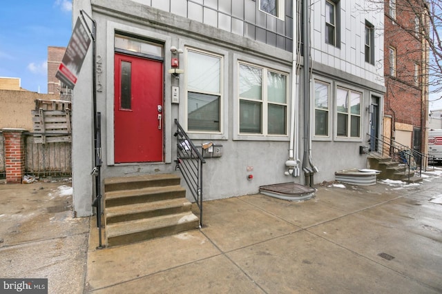 view of exterior entry featuring stucco siding