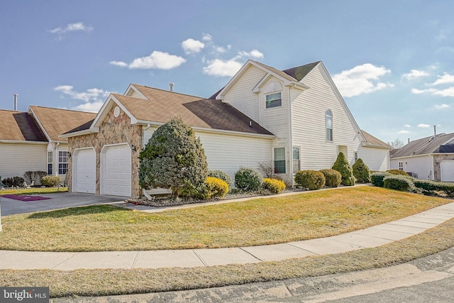 view of front of property with a garage and a front yard