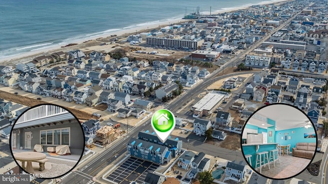 birds eye view of property featuring a water view and a beach view