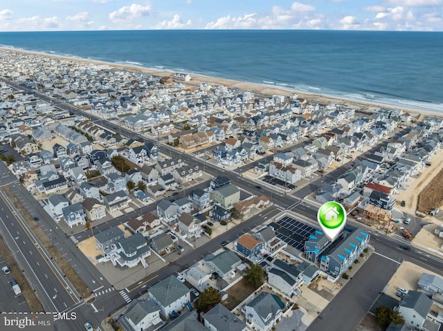 drone / aerial view featuring a view of the beach and a water view