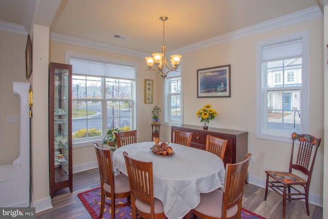 dining room with ornamental molding, plenty of natural light, and dark hardwood / wood-style flooring