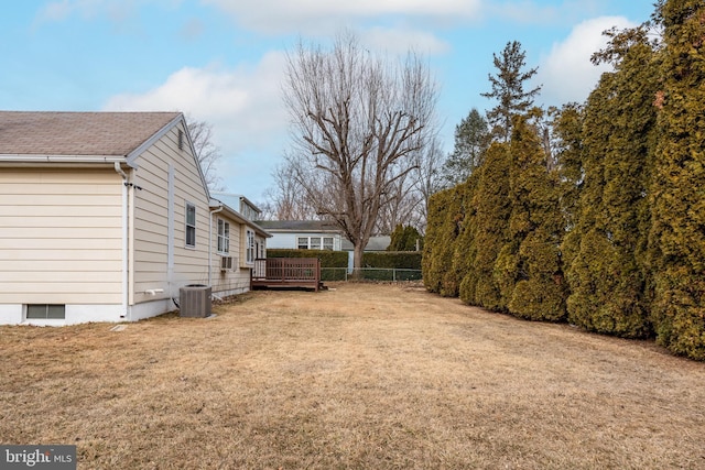 view of yard featuring central AC and a deck