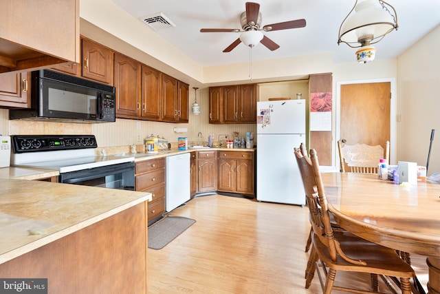 kitchen with ceiling fan, light wood-type flooring, and white appliances