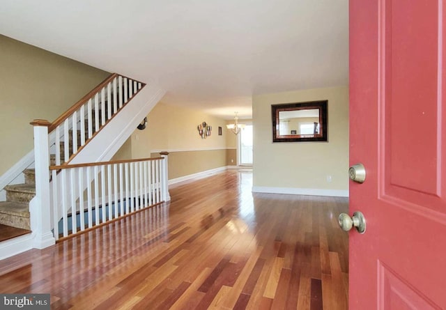 entryway featuring wood-type flooring and a chandelier