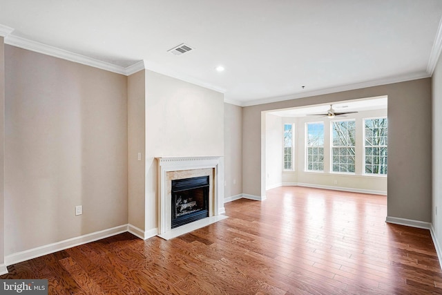 unfurnished living room featuring ornamental molding, hardwood / wood-style floors, and a premium fireplace