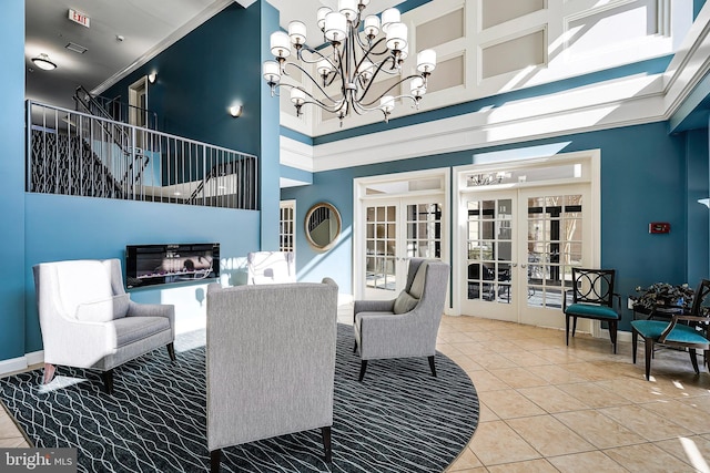 tiled dining room with french doors, a chandelier, and a towering ceiling