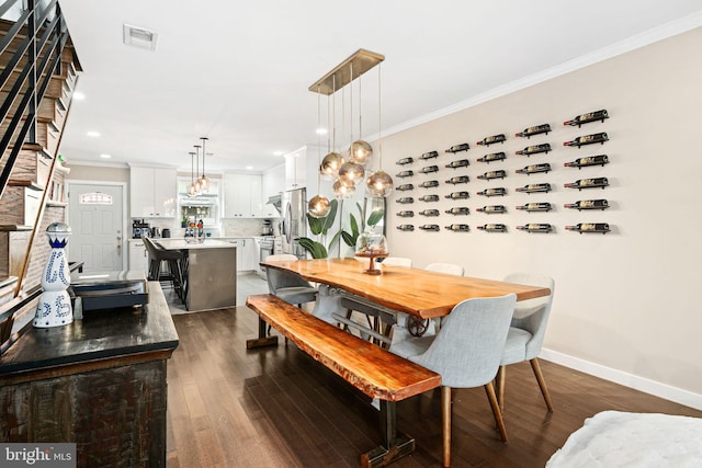 dining area with crown molding and dark hardwood / wood-style flooring