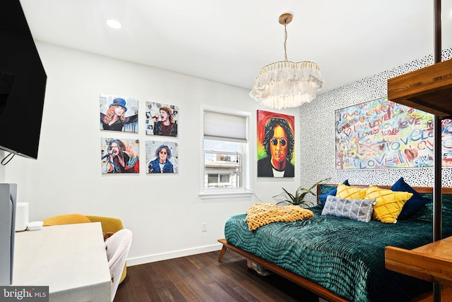 bedroom featuring an inviting chandelier and dark hardwood / wood-style flooring