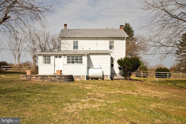 rear view of house with a yard