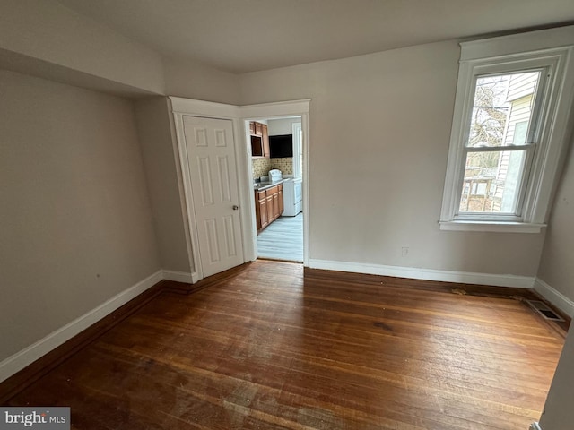 unfurnished room featuring dark hardwood / wood-style floors