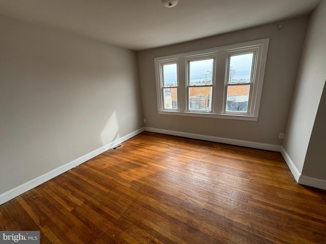 unfurnished room featuring wood-type flooring