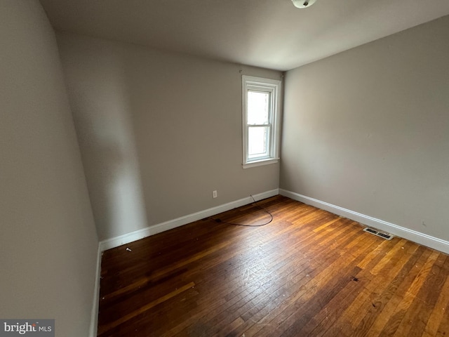 unfurnished room with wood-type flooring