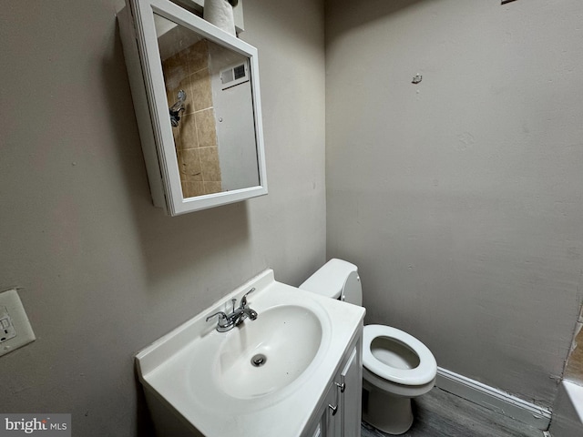 bathroom featuring vanity, hardwood / wood-style floors, and toilet