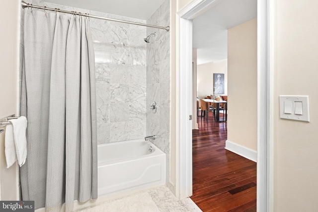 bathroom with shower / tub combo with curtain and wood-type flooring