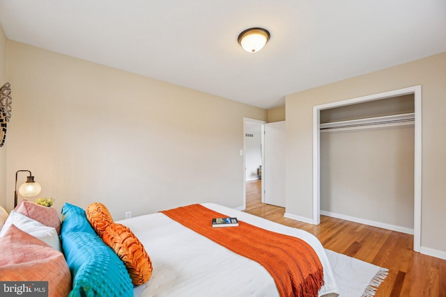 bedroom with wood-type flooring and a closet