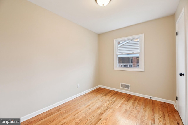 empty room with light hardwood / wood-style flooring