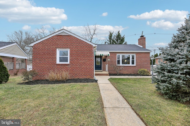 bungalow-style home with a front yard