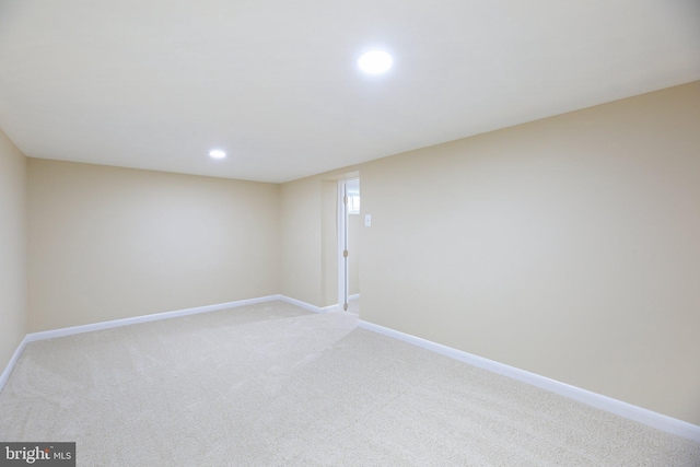 unfurnished room with light colored carpet