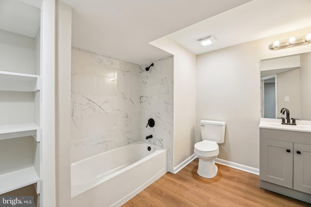 full bathroom with vanity, tiled shower / bath combo, wood-type flooring, and toilet