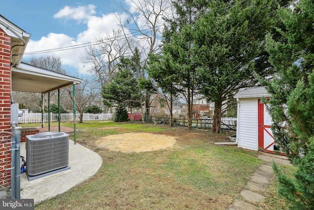 view of yard featuring a storage shed and central air condition unit