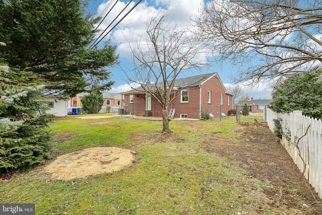 rear view of property with a lawn