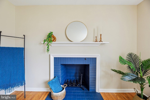 room details featuring hardwood / wood-style floors and a brick fireplace