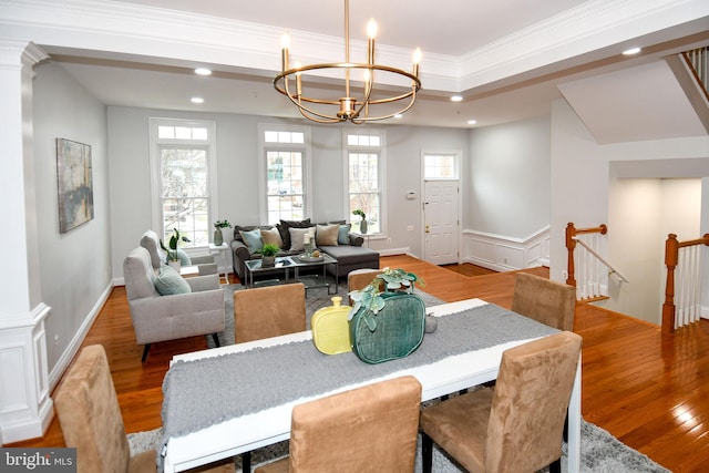 dining space with recessed lighting, a notable chandelier, wood finished floors, and crown molding