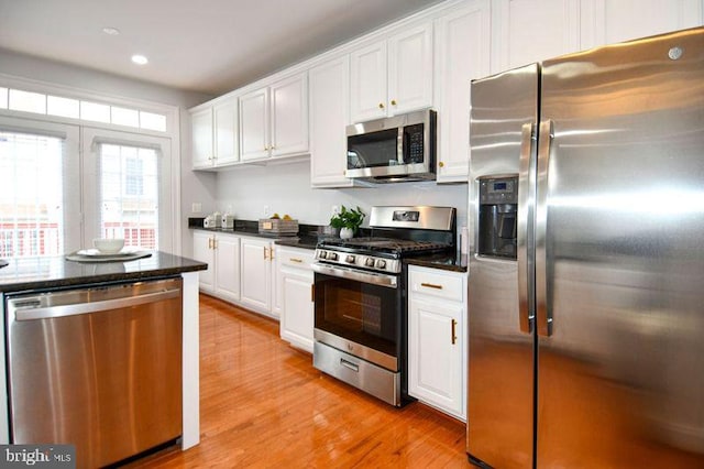 kitchen featuring white cabinets, recessed lighting, light wood-style flooring, and appliances with stainless steel finishes