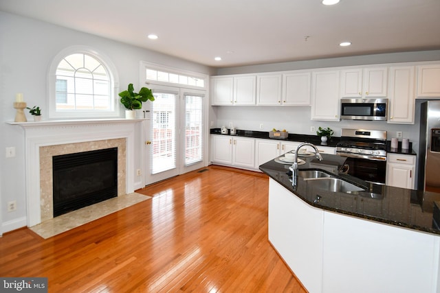 kitchen with recessed lighting, stainless steel appliances, light wood-style flooring, and white cabinetry