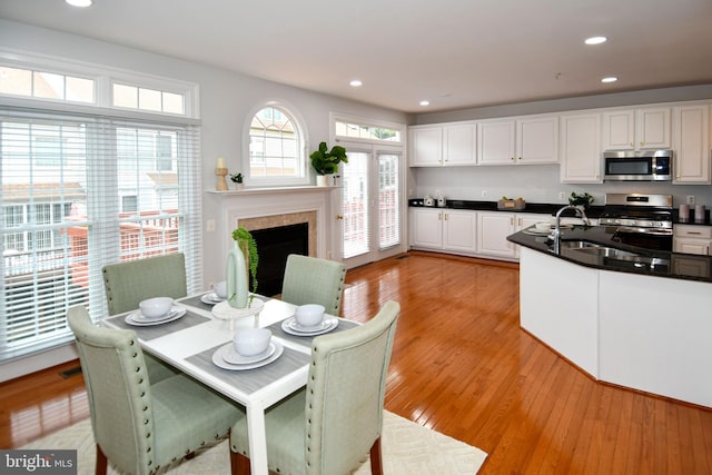 kitchen with dark countertops, light wood-style flooring, recessed lighting, and stainless steel appliances