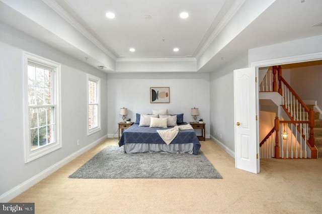 bedroom with light carpet, a tray ceiling, recessed lighting, crown molding, and baseboards