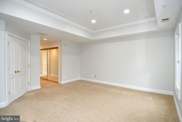 interior space with recessed lighting, visible vents, light carpet, and a raised ceiling