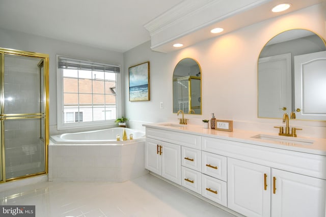 bathroom featuring a shower stall, a bath, double vanity, and a sink