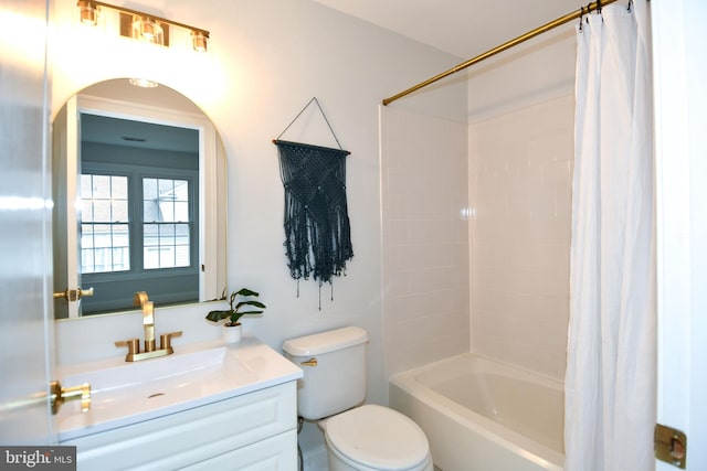 bathroom with vanity, toilet, and shower / tub combo with curtain