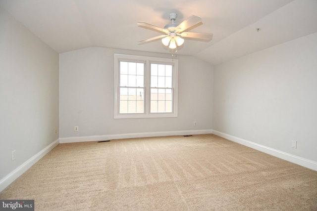 interior space featuring visible vents, baseboards, ceiling fan, and vaulted ceiling