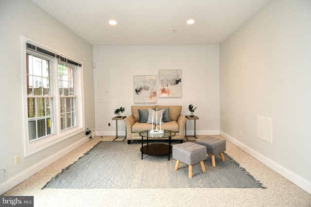 living area featuring recessed lighting and baseboards