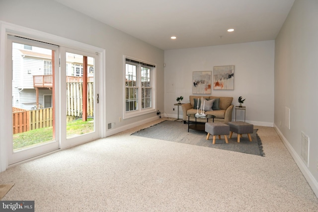 sitting room with carpet, recessed lighting, visible vents, and baseboards