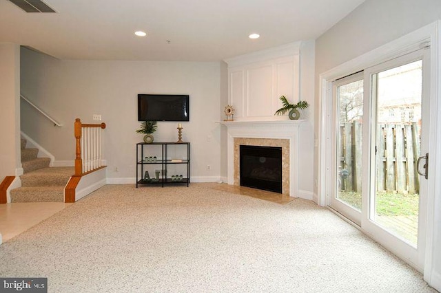 living room with stairs, plenty of natural light, recessed lighting, and visible vents