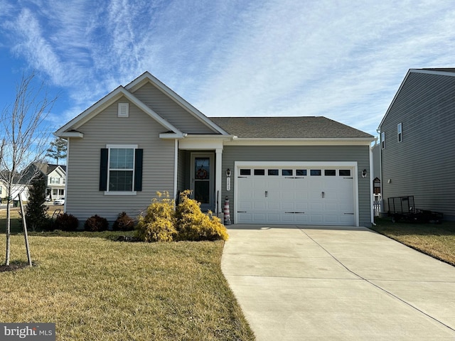 view of front of home featuring a garage and a front yard