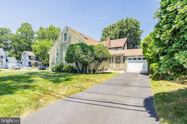 view of front of home featuring a garage and a front lawn