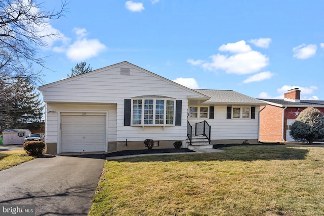 single story home featuring a front lawn and a garage