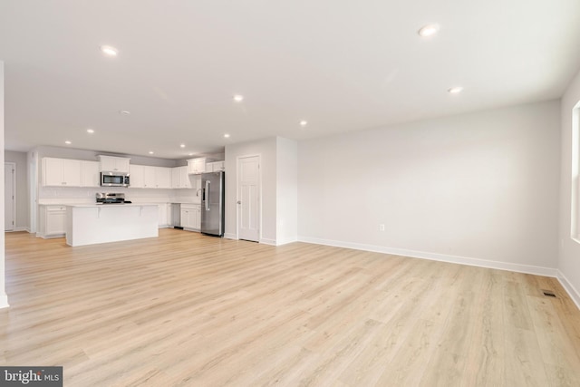 unfurnished living room featuring light wood-type flooring